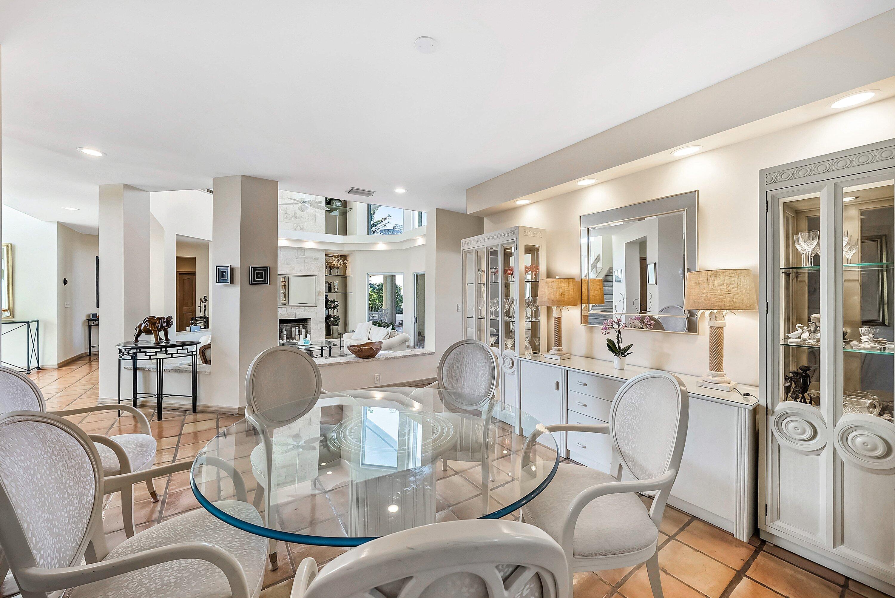 11 Inlet Cay Drive Ocean Ridge, FL 33435 - Photo 11 of 47 a dining room with furniture a kitchen view and wooden floor