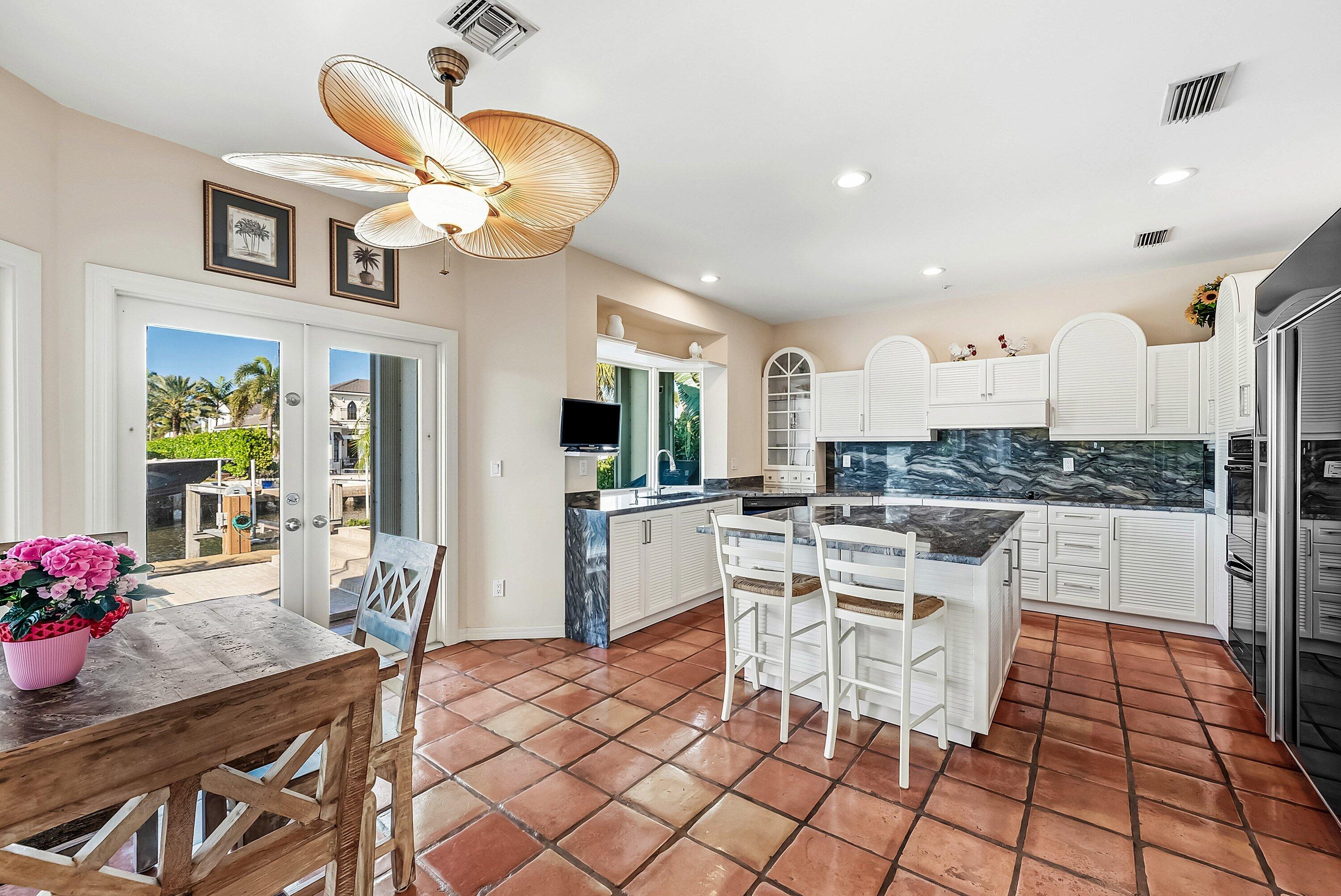 11 Inlet Cay Drive Ocean Ridge, FL 33435 - Photo 12 of 47 a kitchen with stainless steel appliances kitchen island granite countertop a sink and cabinets