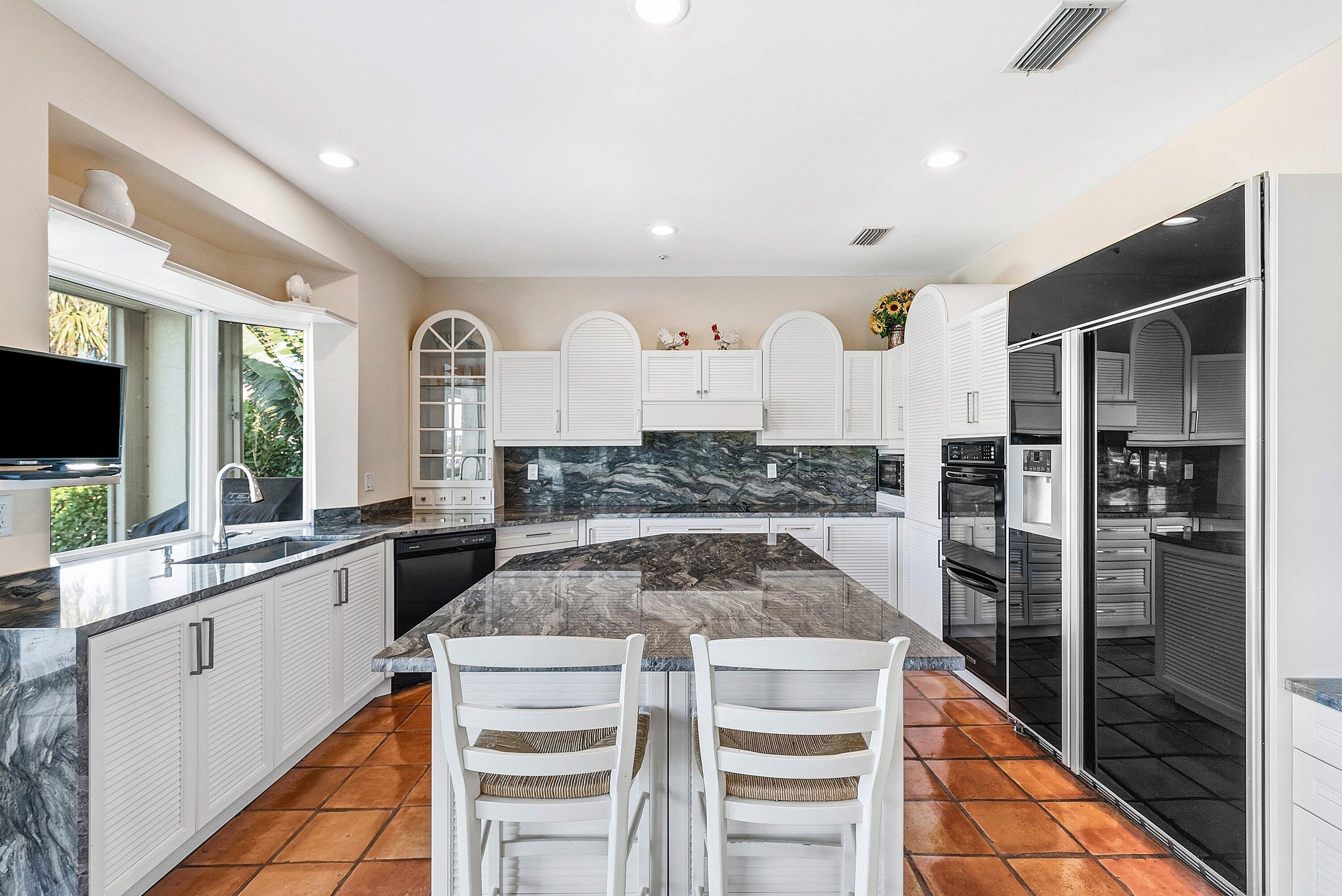 11 Inlet Cay Drive Ocean Ridge, FL 33435 - Photo 13 of 47 a kitchen with a stove a sink and a refrigerator