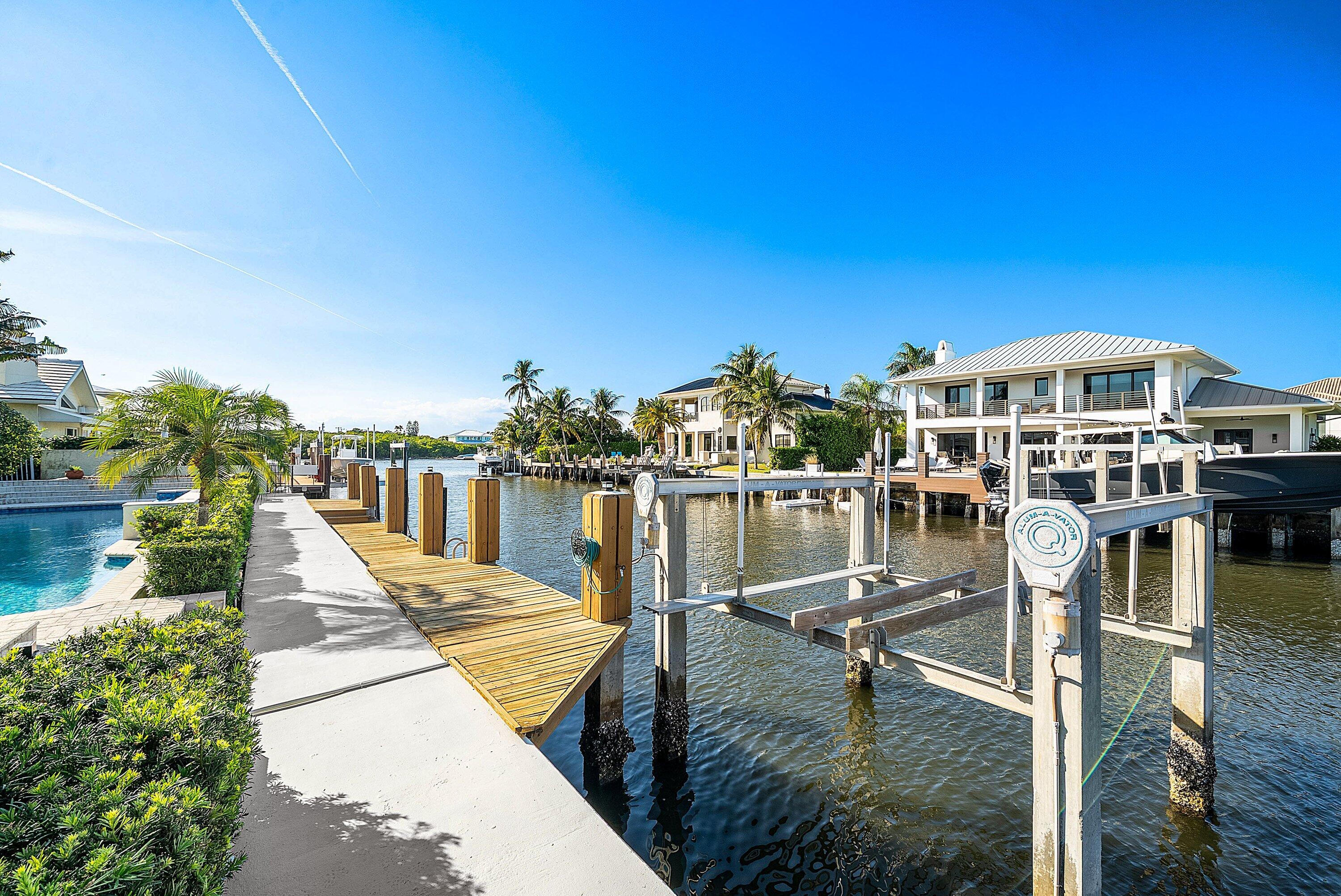 11 Inlet Cay Drive Ocean Ridge, FL 33435 - Photo 18 of 47 a view of a lake with boats and trees in the background