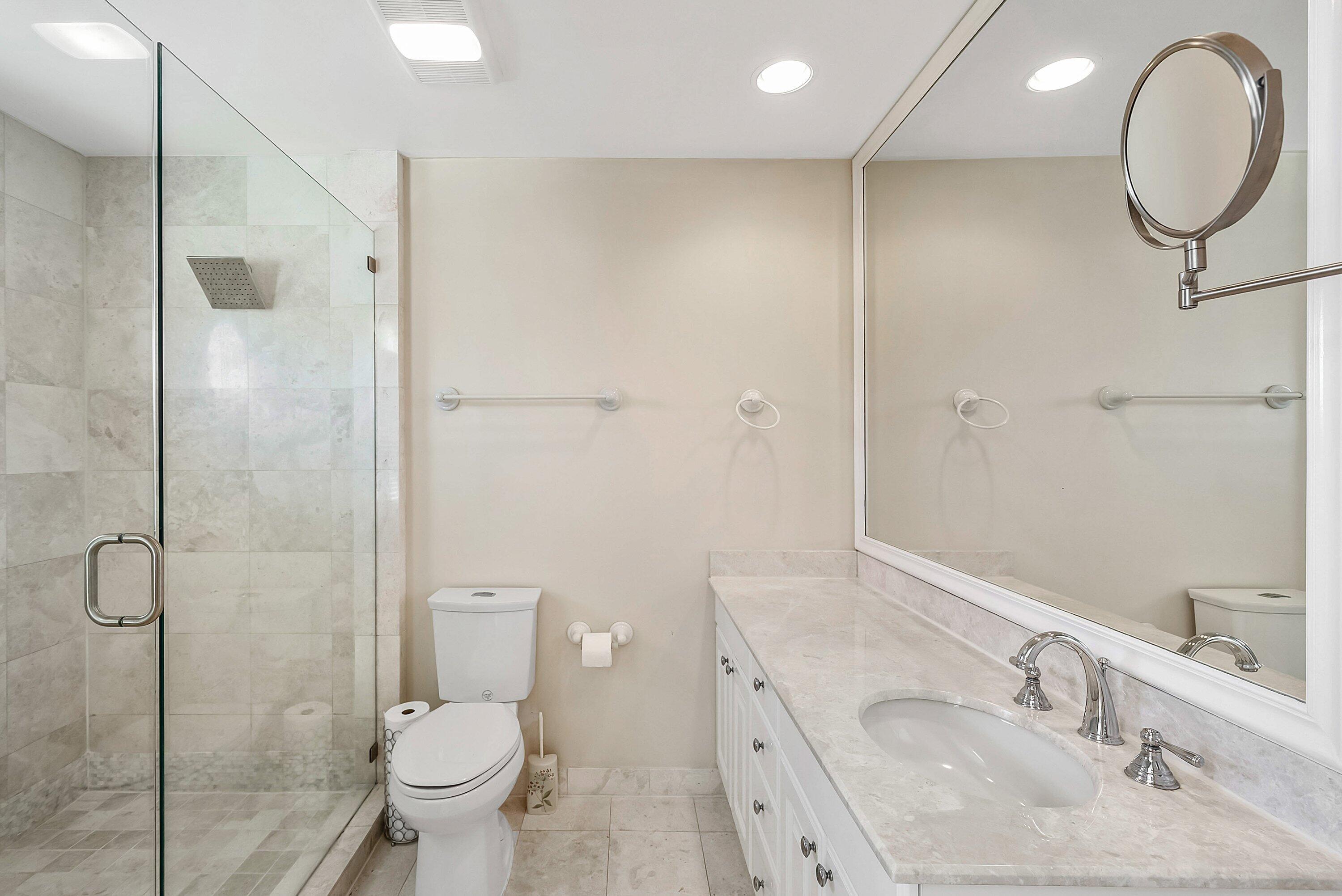 11 Inlet Cay Drive Ocean Ridge, FL 33435 - Photo 27 of 47 a bathroom with a sink toilet and shower