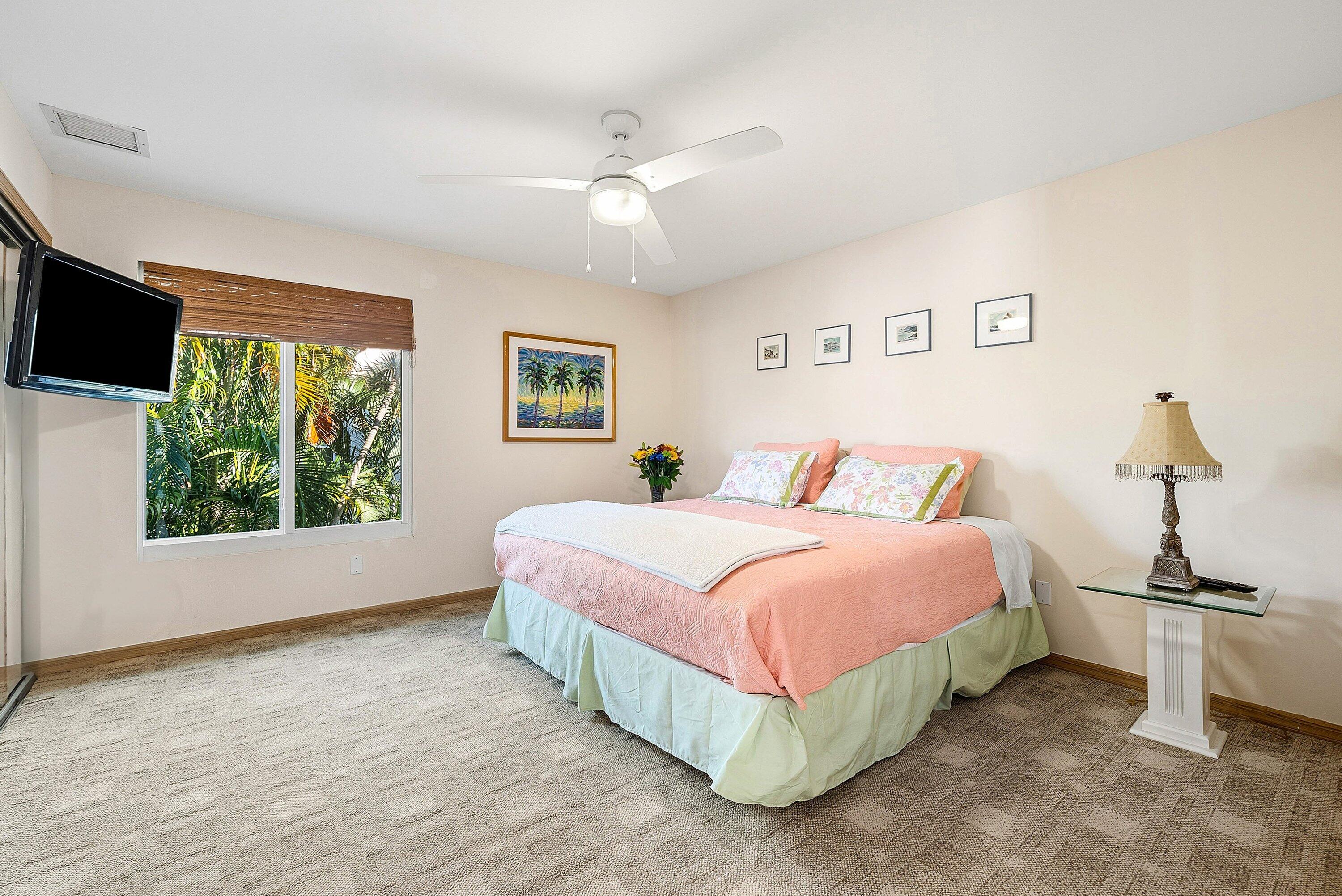 11 Inlet Cay Drive Ocean Ridge, FL 33435 - Photo 28 of 47 a bedroom with a bed and a window