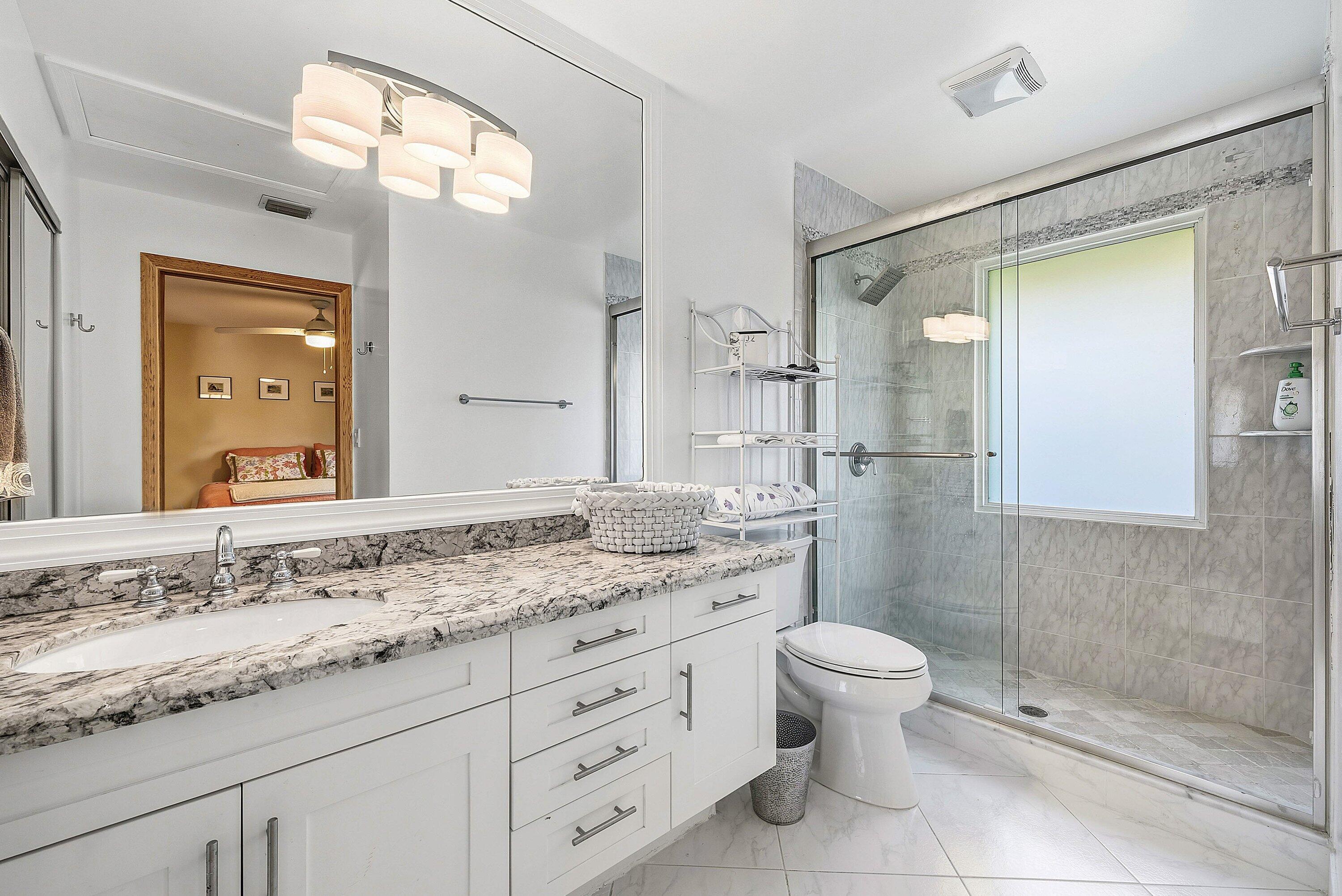 11 Inlet Cay Drive Ocean Ridge, FL 33435 - Photo 29 of 47 a bathroom with a granite countertop sink toilet and shower