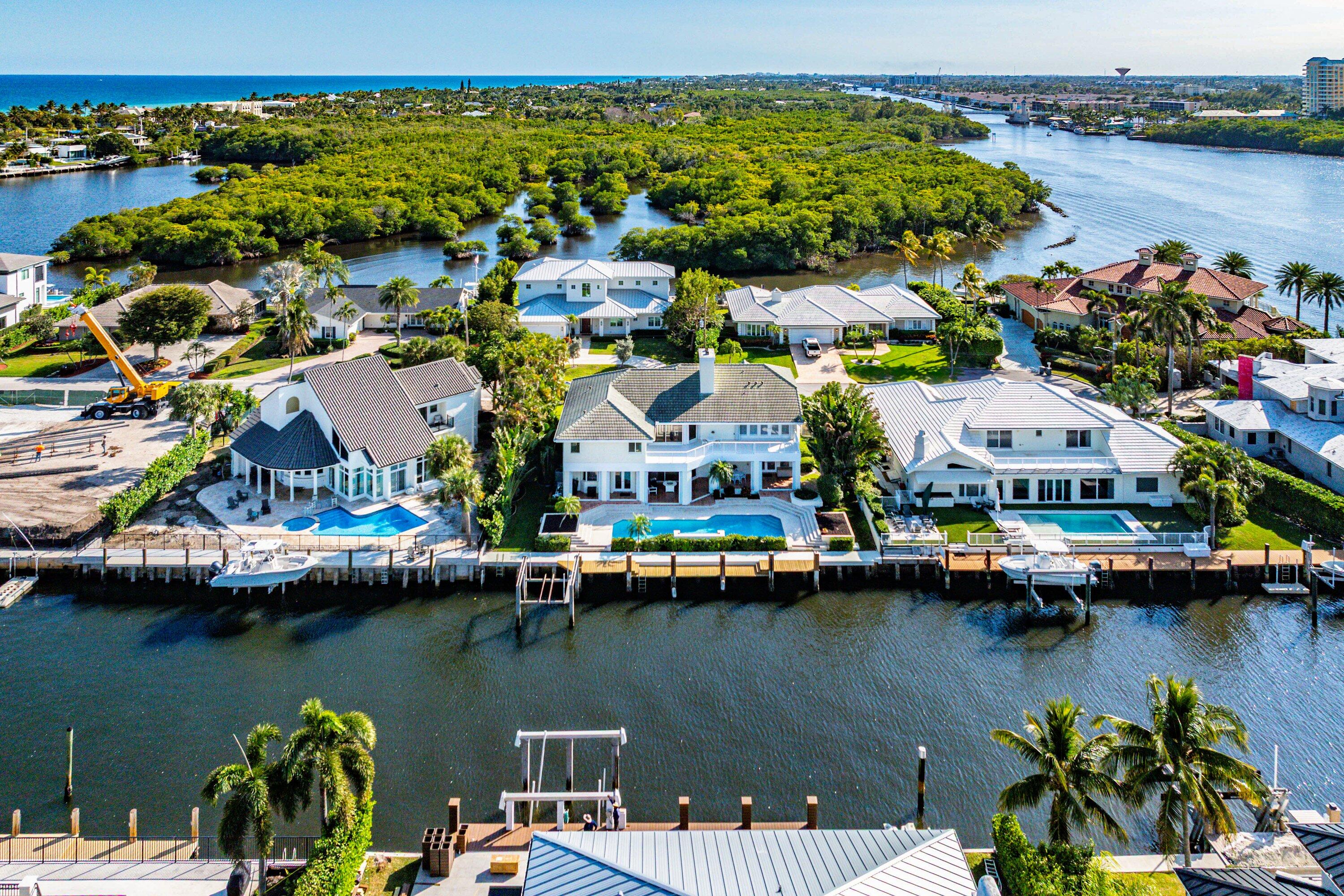 11 Inlet Cay Drive Ocean Ridge, FL 33435 - Photo 3 of 47 a view of a lake with a house and a floor to ceiling window