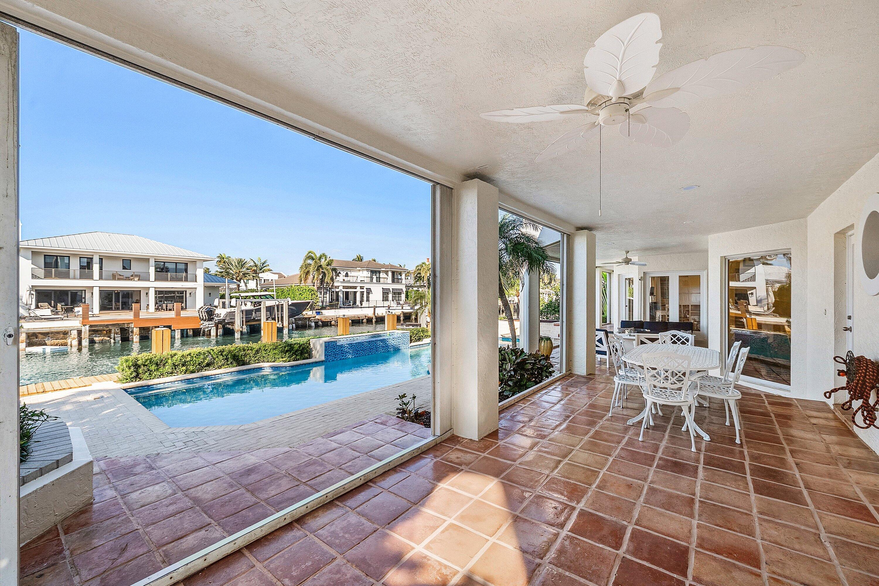 11 Inlet Cay Drive Ocean Ridge, FL 33435 - Photo 39 of 47 a view of a patio with table and chairs