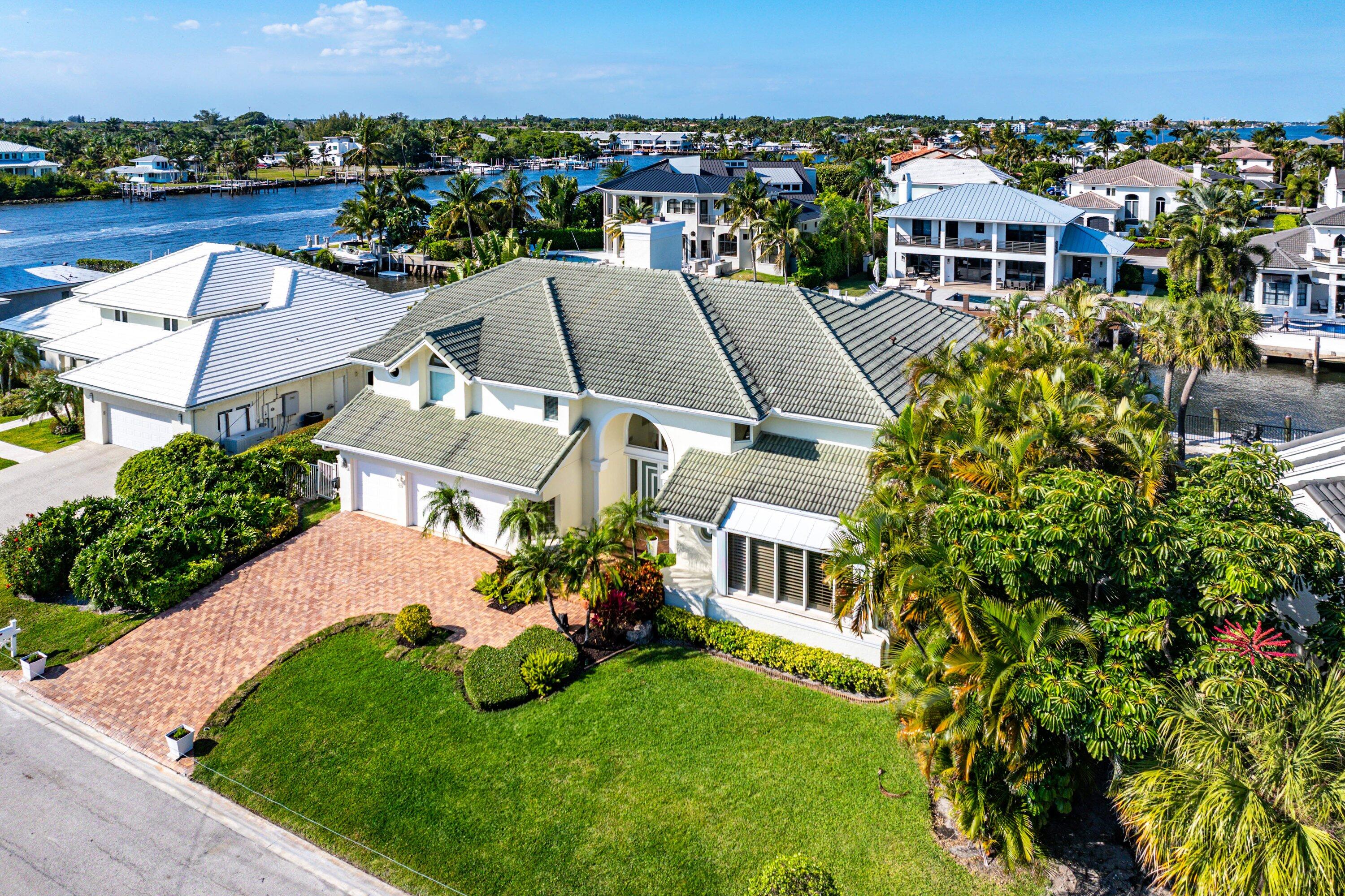 11 Inlet Cay Drive Ocean Ridge, FL 33435 - Photo 4 of 47 an aerial view of multiple houses with a yard