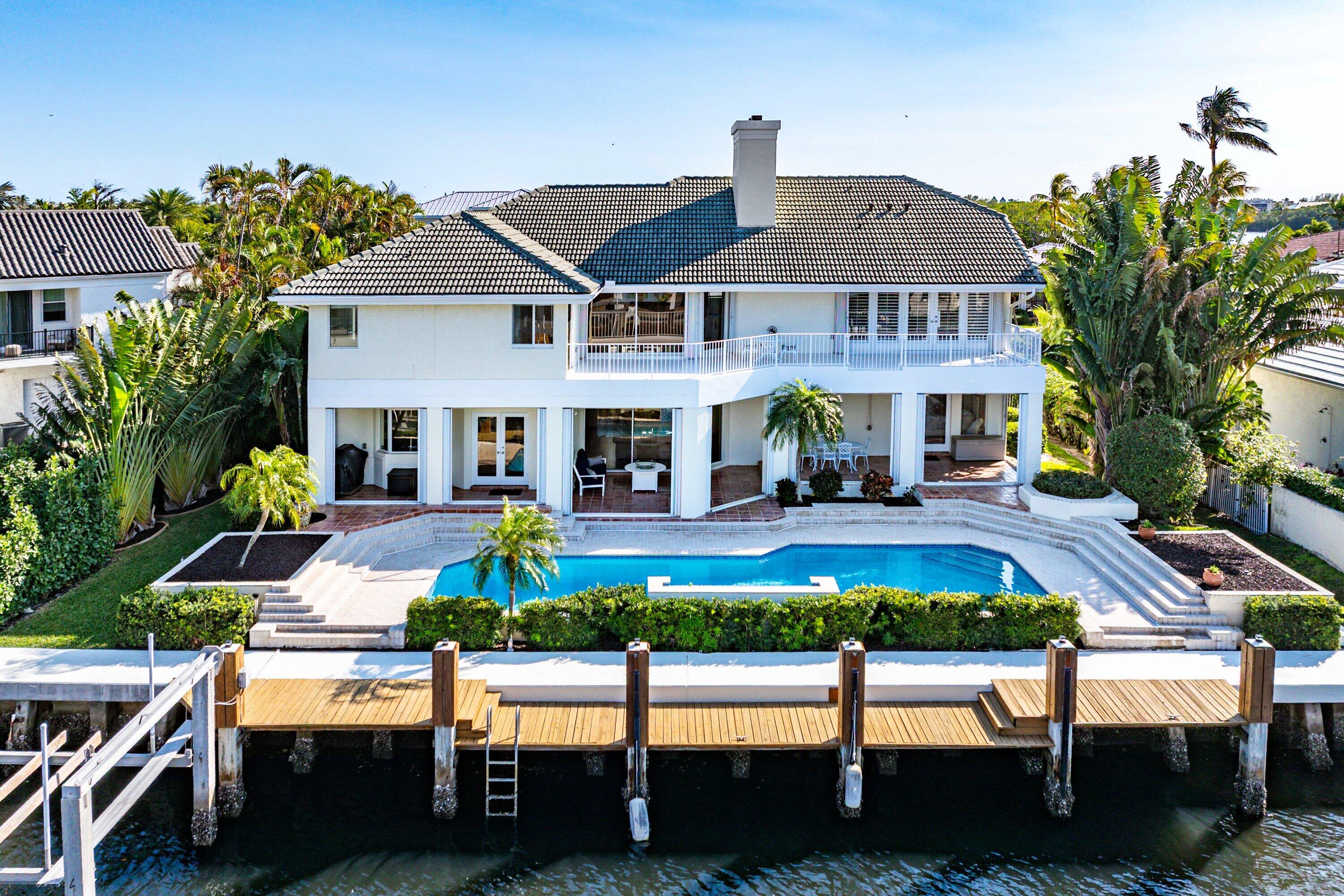 11 Inlet Cay Drive Ocean Ridge, FL 33435 - Photo 45 of 47 a front view of a house with a yard table and chairs