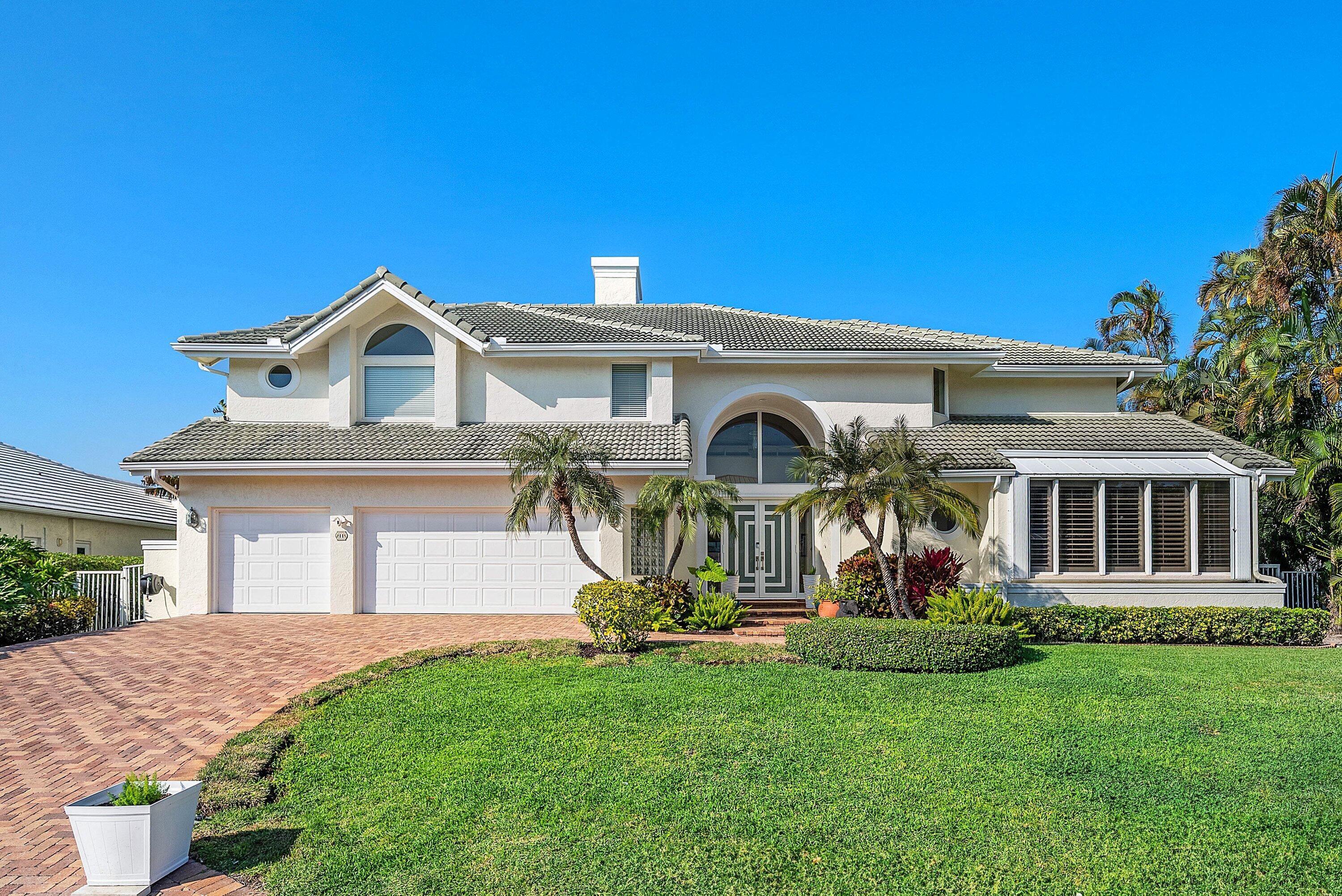 11 Inlet Cay Drive Ocean Ridge, FL 33435 - Photo 6 of 47 front view of a house with a yard