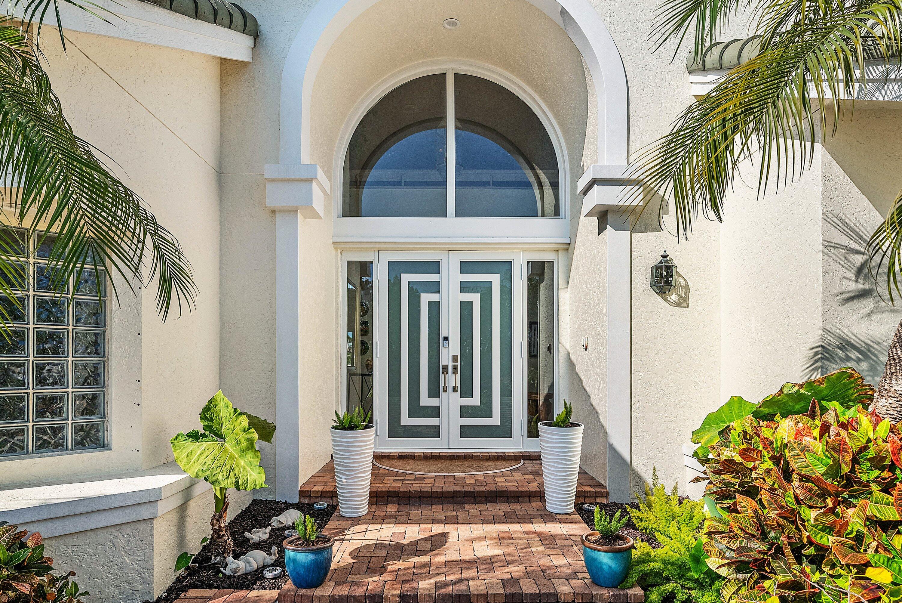 11 Inlet Cay Drive Ocean Ridge, FL 33435 - Photo 7 of 47 a front view of a house with a yard