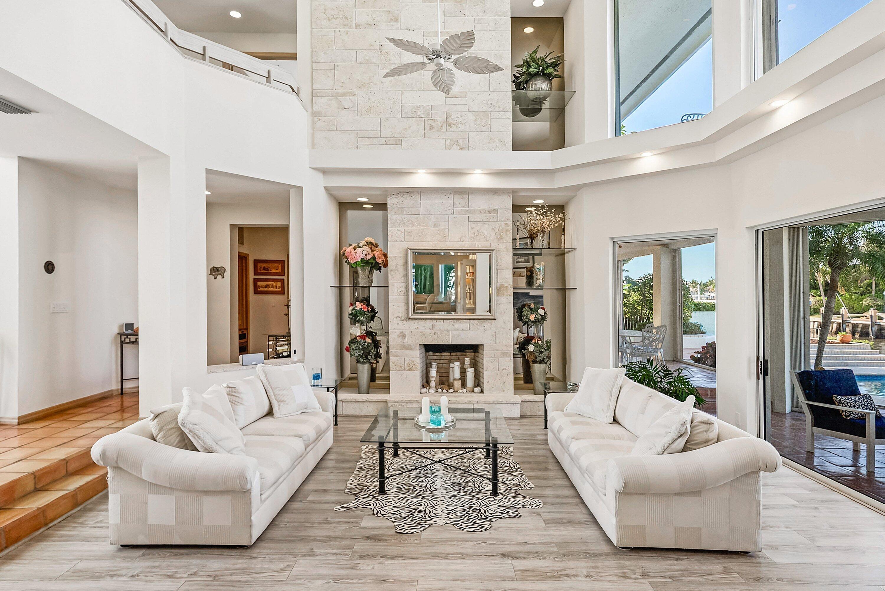 11 Inlet Cay Drive Ocean Ridge, FL 33435 - Photo 8 of 47 a living room with fireplace furniture and a large window