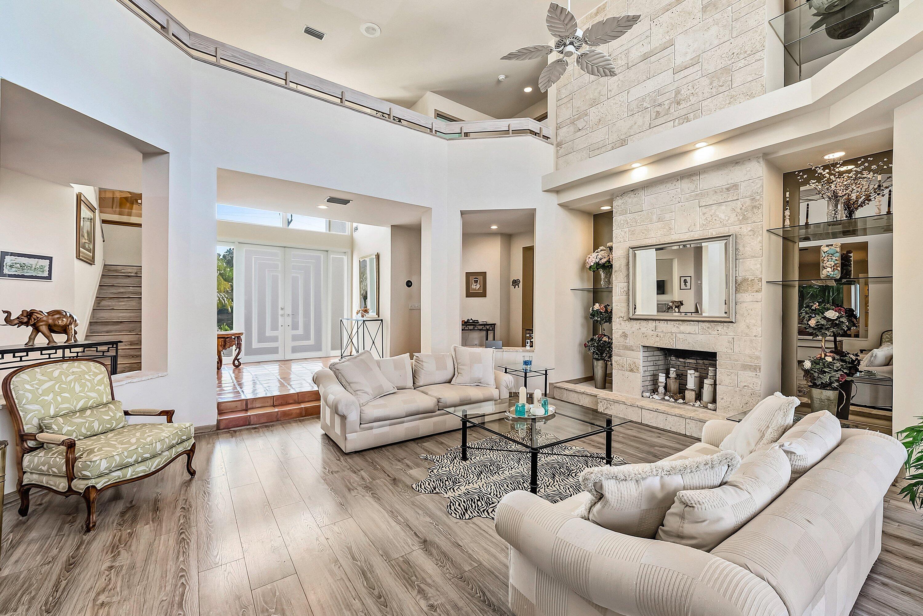 11 Inlet Cay Drive Ocean Ridge, FL 33435 - Photo 9 of 47 a living room with furniture dining area and a fireplace