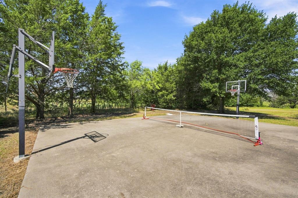 9732 Timber Trail Scurry, TX 75158 - Photo 37 of 39 Cement slab with basketball / pickleball / racquetball possibilities (or possible building)