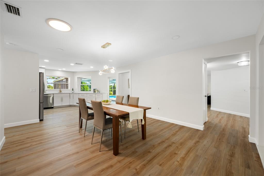 656 Mehlenbacher Road Belleair, FL 33756 - Photo 7 of 49 a view of a dining room with furniture and wooden floor