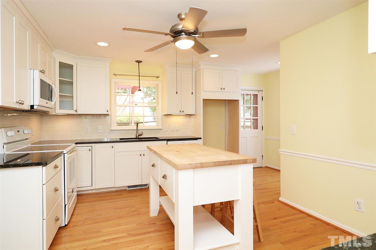 5027 Winterlochen Road Raleigh, NC 27603 - Photo 2 of 25 a kitchen with a stove a sink and a refrigerator