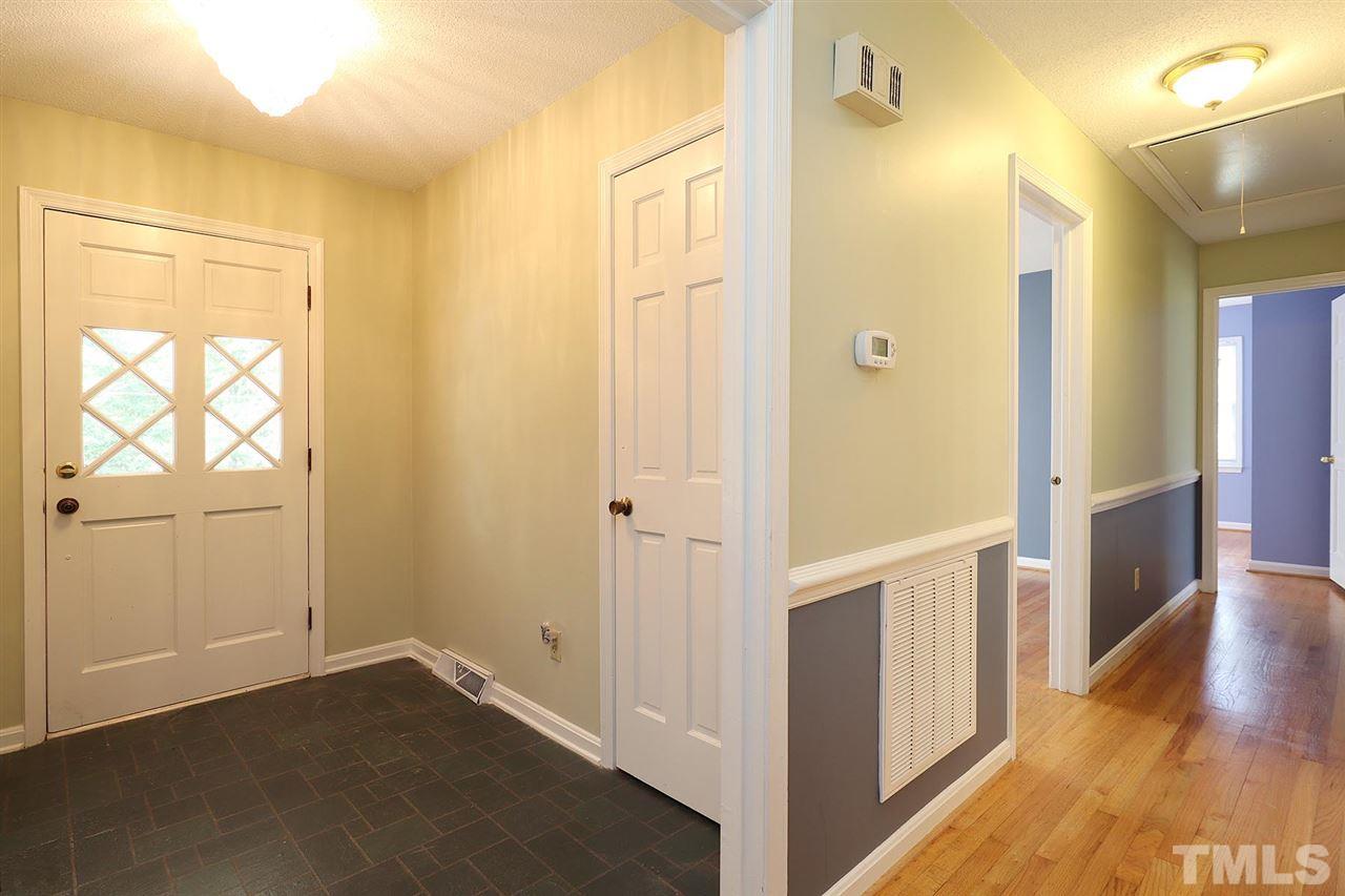 5027 Winterlochen Road Raleigh, NC 27603 - Photo 11 of 25 a view of an empty room with wooden floor and a window