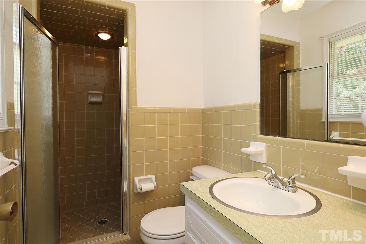 5027 Winterlochen Road Raleigh, NC 27603 - Photo 14 of 25 a bathroom with a sink a toilet and shower