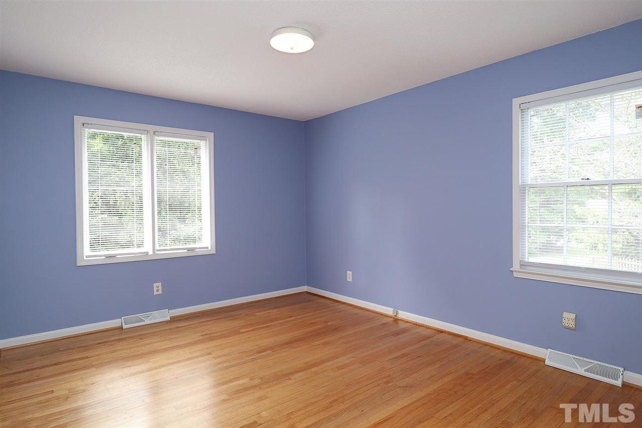5027 Winterlochen Road Raleigh, NC 27603 - Photo 15 of 25 a view of an empty room with wooden floor and a window