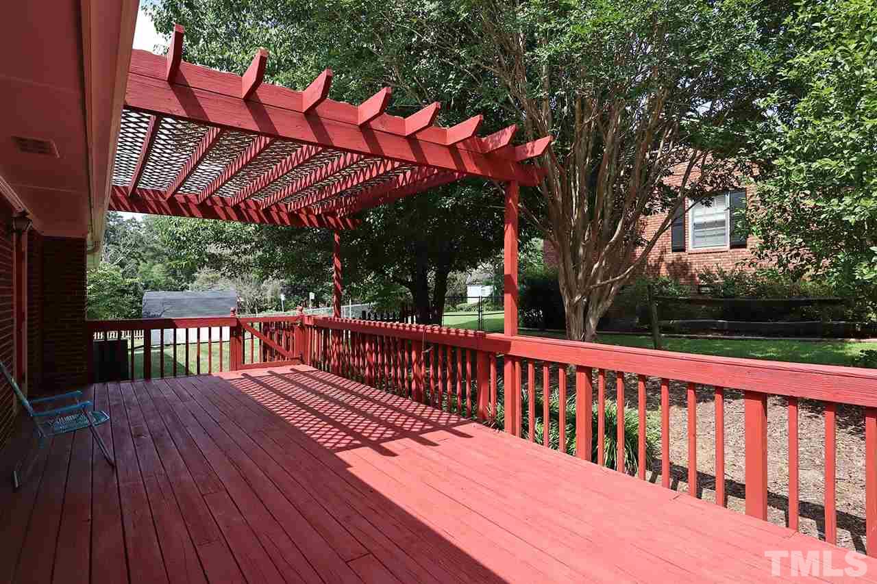 5027 Winterlochen Road Raleigh, NC 27603 - Photo 18 of 25 a view of a wooden deck with a bench