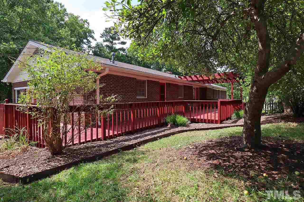 5027 Winterlochen Road Raleigh, NC 27603 - Photo 19 of 25 a view of a house with backyard and wooden fence