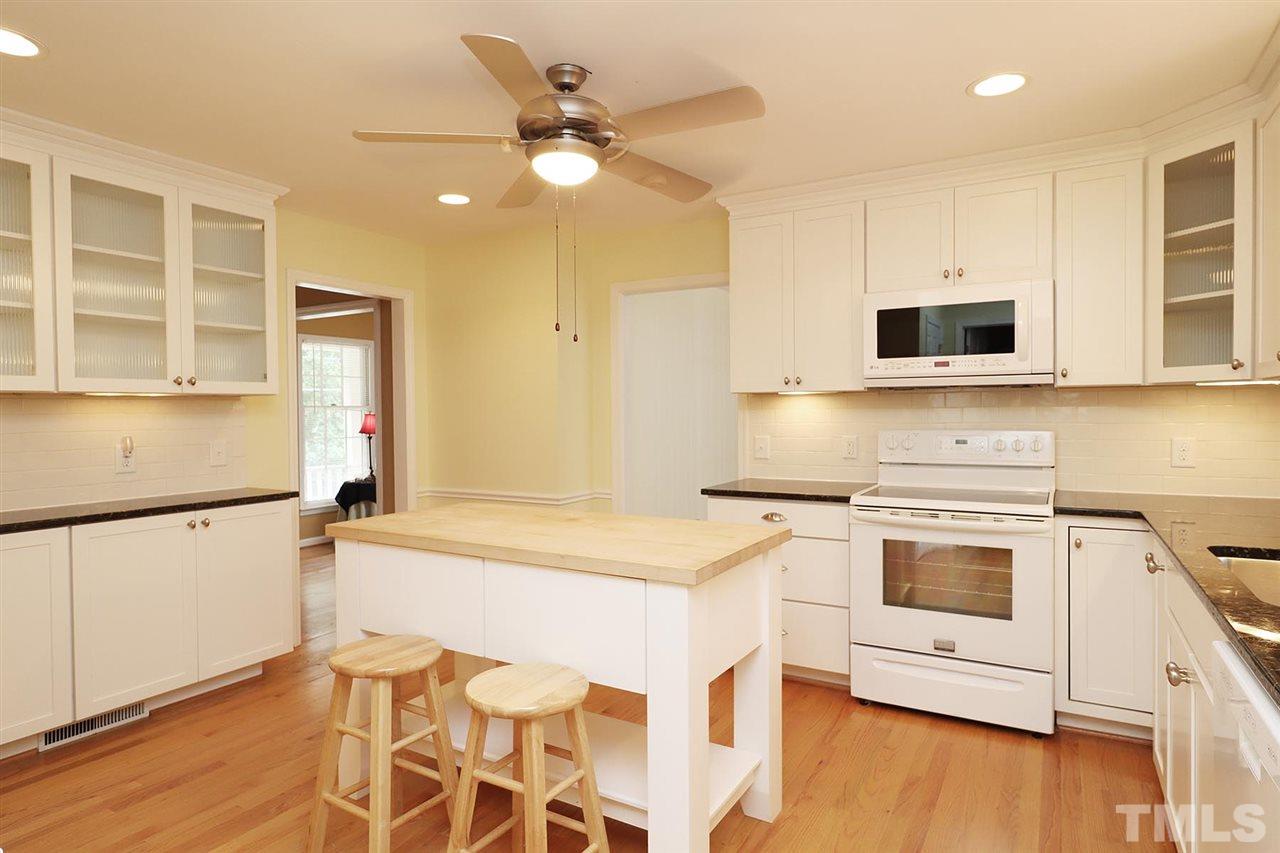 5027 Winterlochen Road Raleigh, NC 27603 - Photo 3 of 25 a kitchen with a stove a sink and a microwave