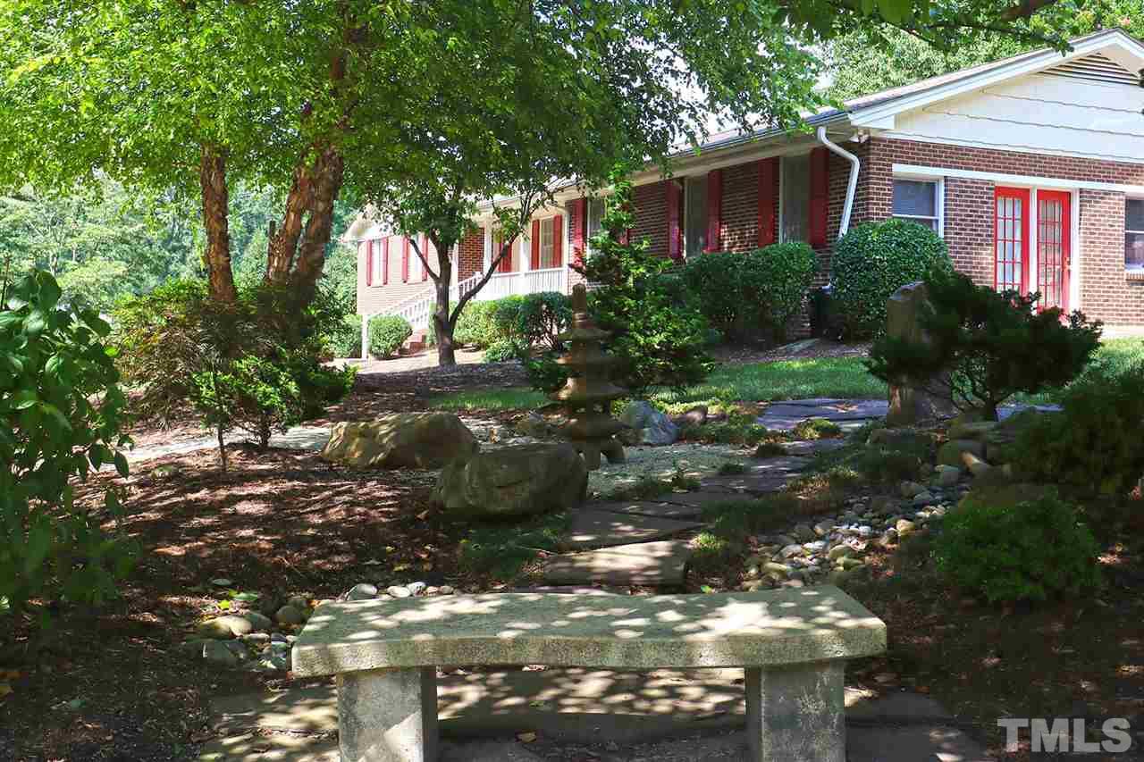 5027 Winterlochen Road Raleigh, NC 27603 - Photo 23 of 25 a view of a tree in front of a house