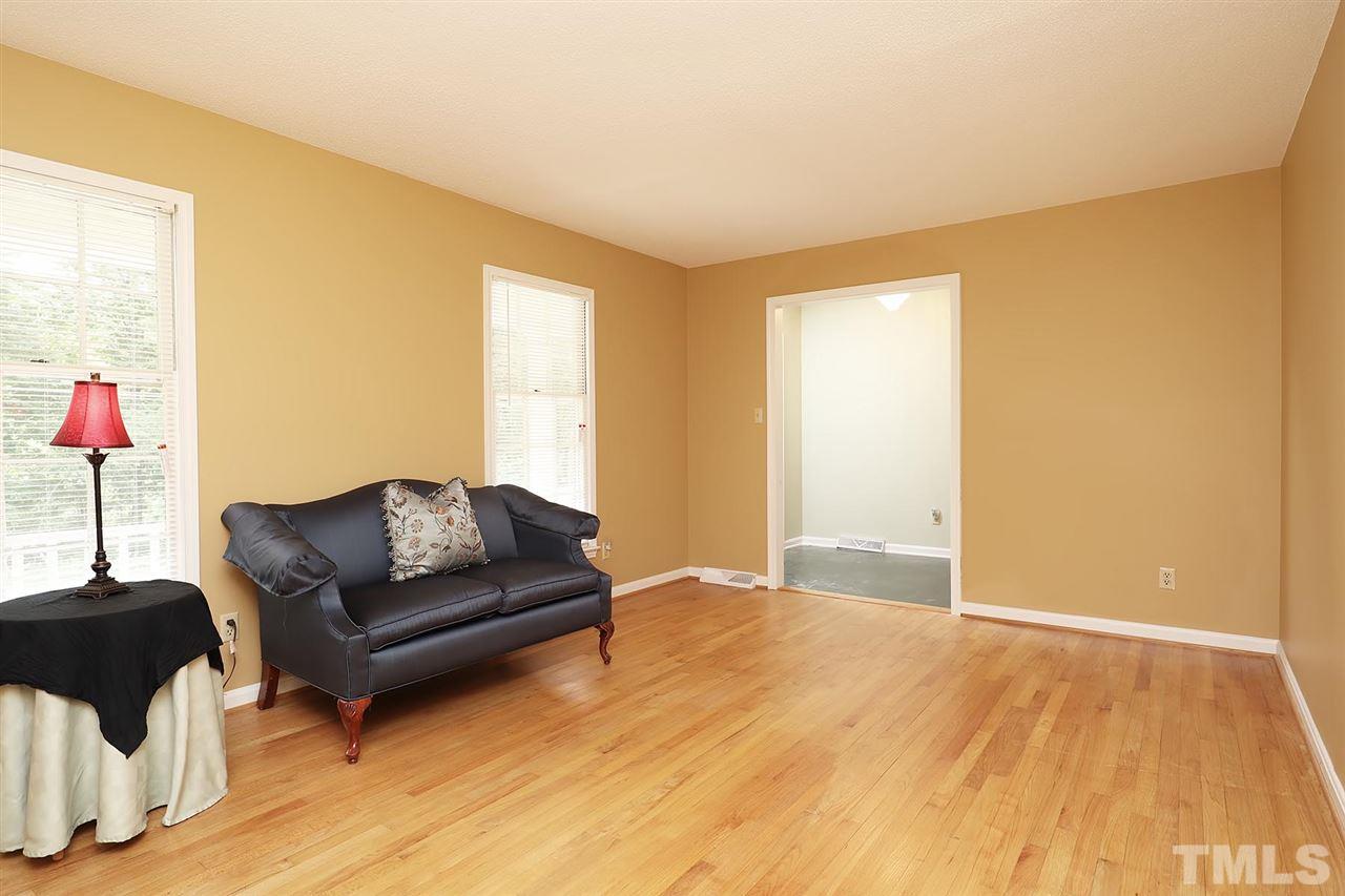 5027 Winterlochen Road Raleigh, NC 27603 - Photo 4 of 25 a living room with furniture and a wooden floor