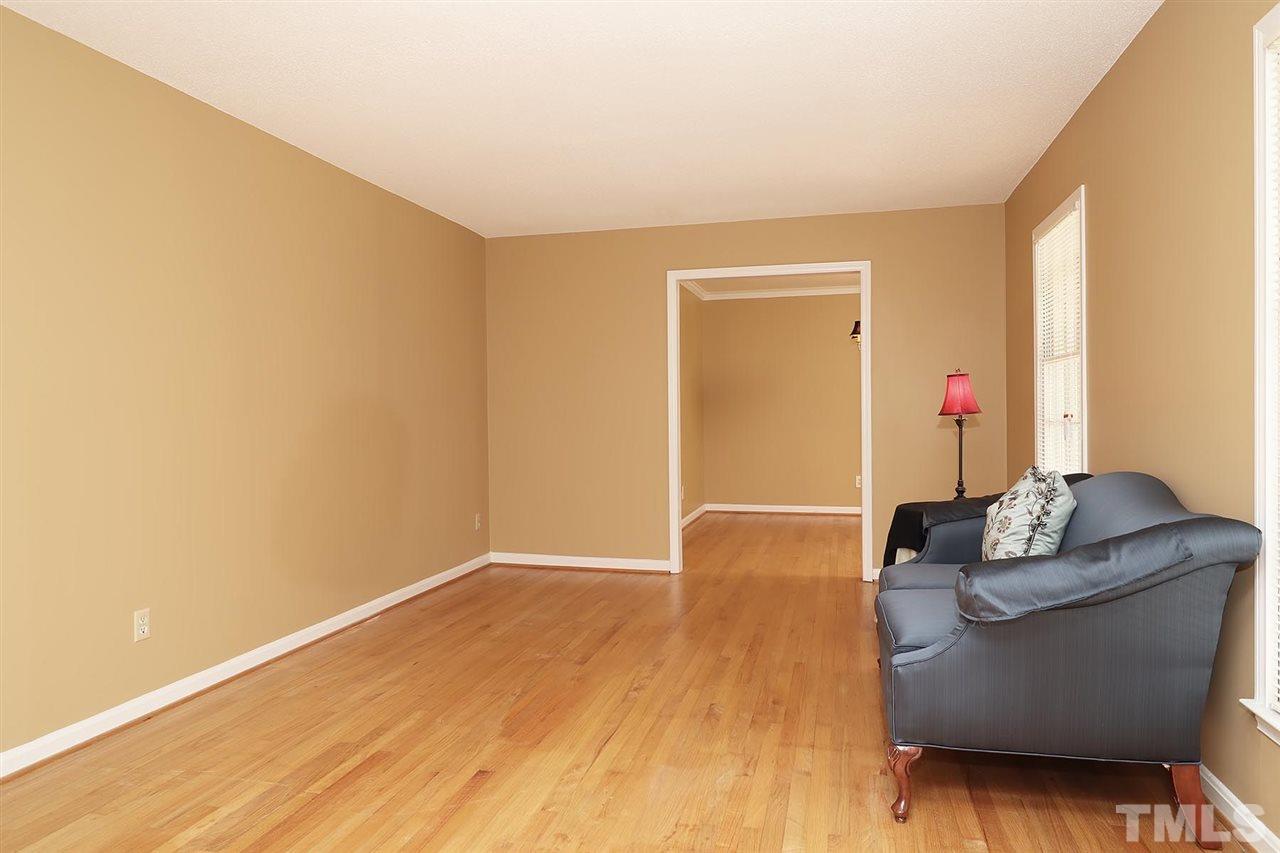 5027 Winterlochen Road Raleigh, NC 27603 - Photo 5 of 25 a living room with furniture and a wooden floor