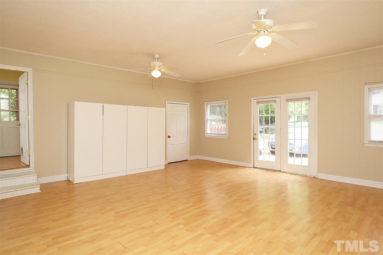 5027 Winterlochen Road Raleigh, NC 27603 - Photo 7 of 25 an empty room with windows and ceiling fan