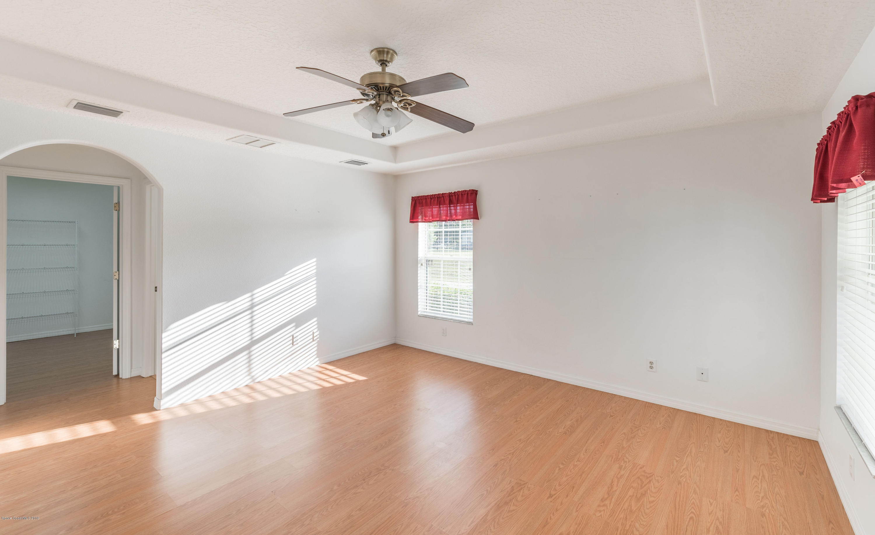3700 Grant Line Road Mims, FL 32754 - Photo 22 of 40 a view of a big room with wooden floor and windows in a room