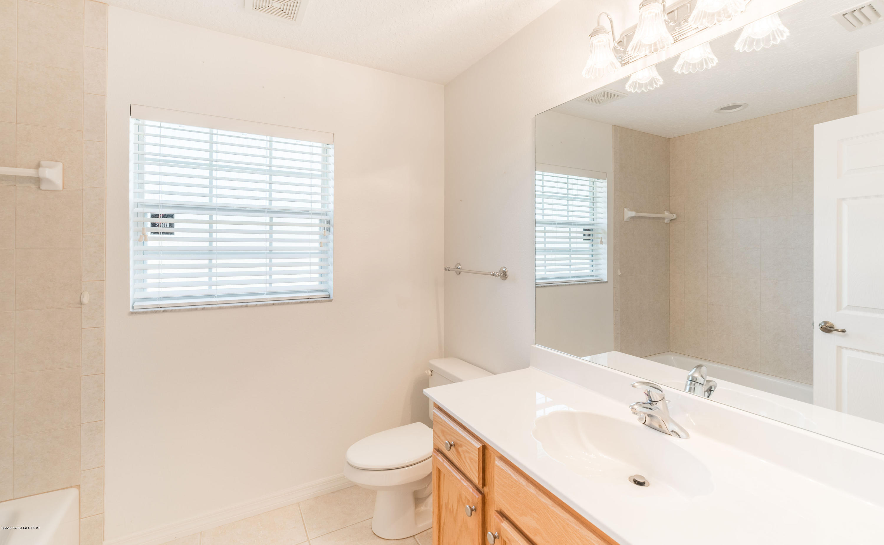 3700 Grant Line Road Mims, FL 32754 - Photo 29 of 40 a bathroom with a sink toilet and a mirror