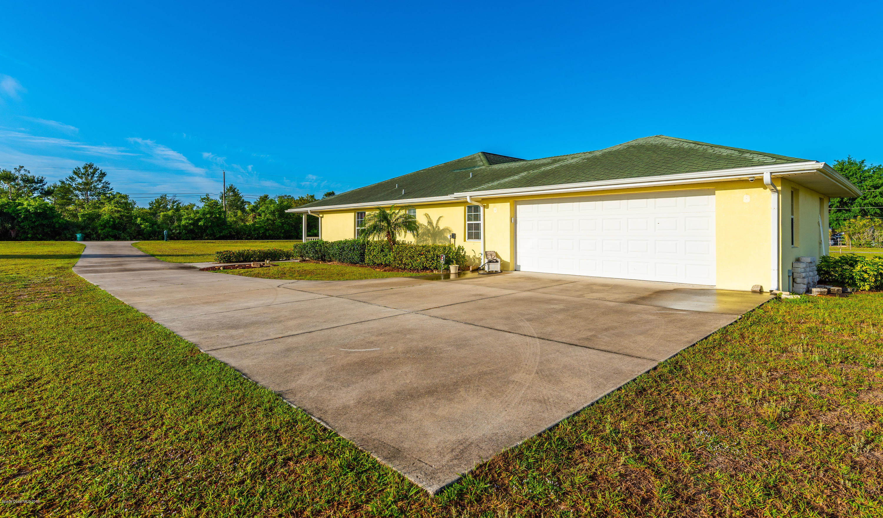 3700 Grant Line Road Mims, FL 32754 - Photo 4 of 40 a view of a house with a yard and garage