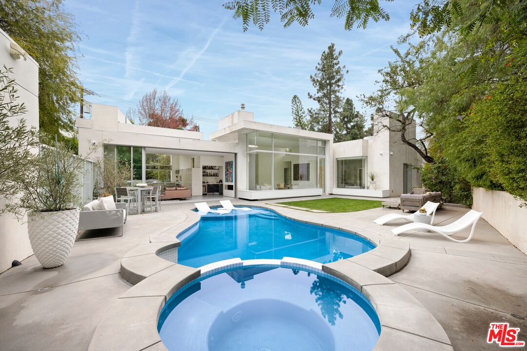 2654 Roscomare Road Los Angeles, CA 90077 - Photo 1 of 29 a view of a house with swimming pool and sitting area