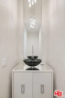 a close view of a sink a counter space and a chandelier