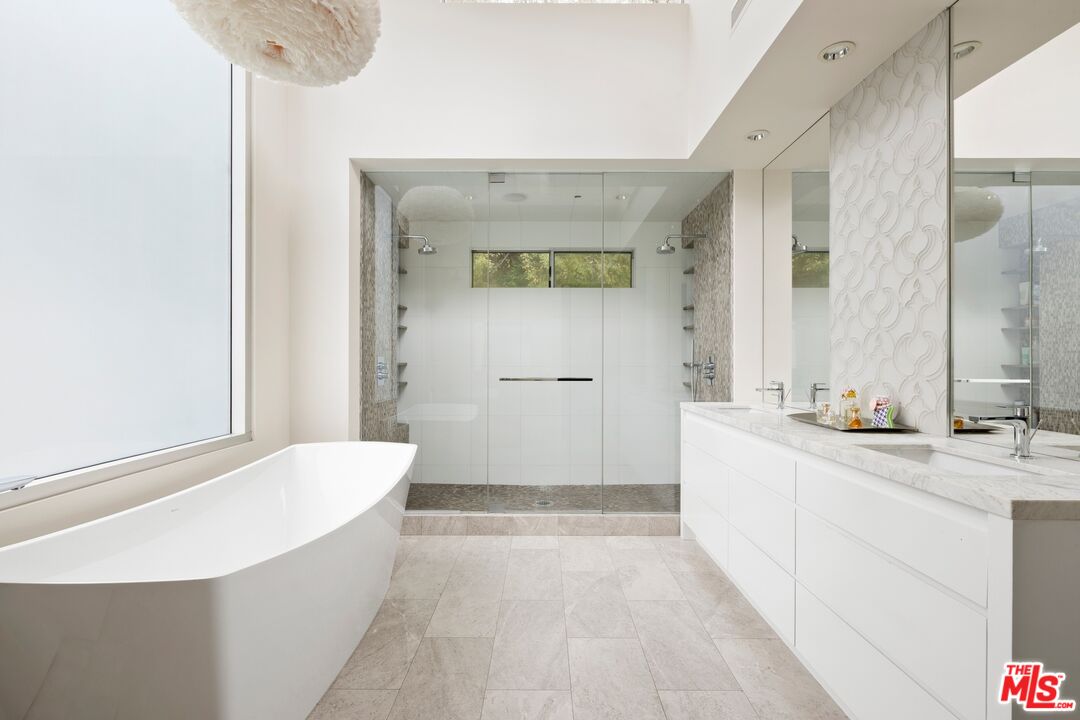 2654 Roscomare Road Los Angeles, CA 90077 - Photo 18 of 29 a bathroom with a tub sink and mirror