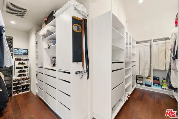 a view of walk in closet with white walls