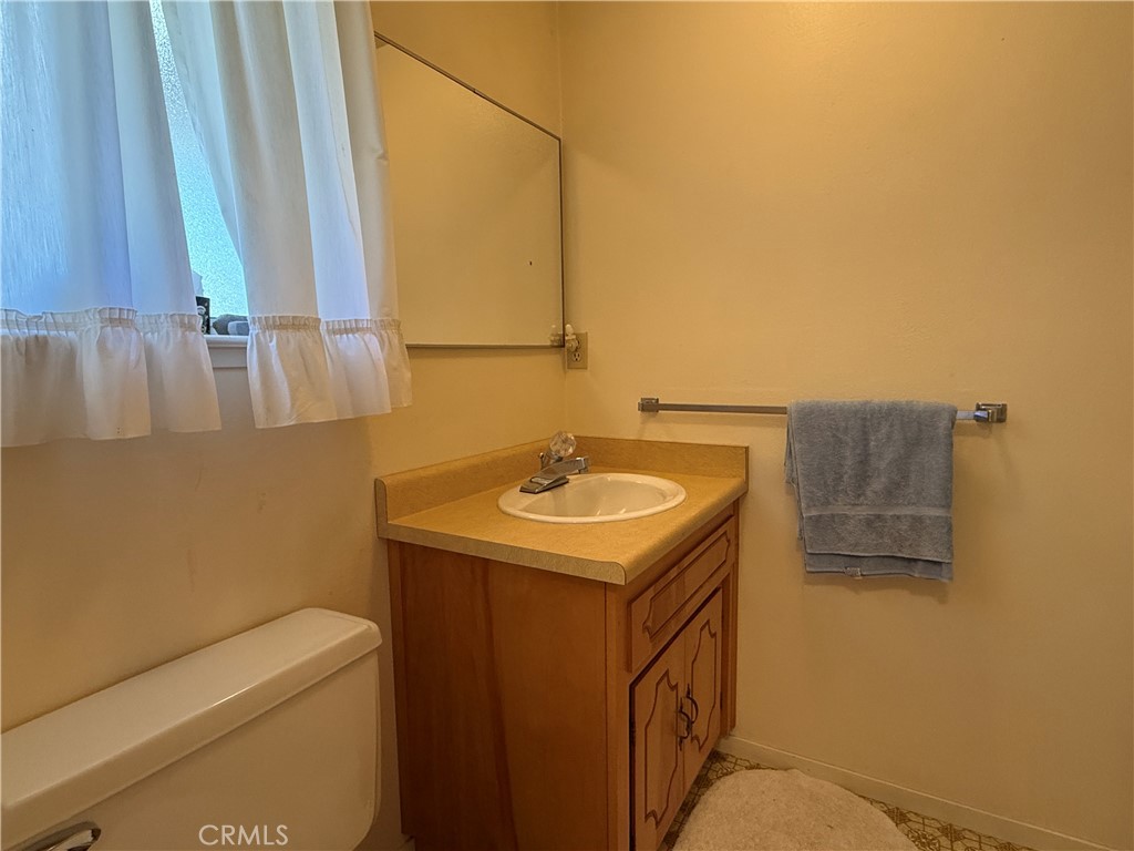 4952 Hidden Springs Road Mariposa, CA 95338 - Photo 27 of 53 a bathroom with a sink a vanity and mirror