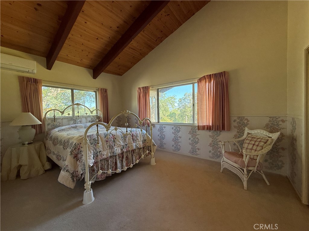 4952 Hidden Springs Road Mariposa, CA 95338 - Photo 34 of 53 a bed sitting in a bedroom next to a window