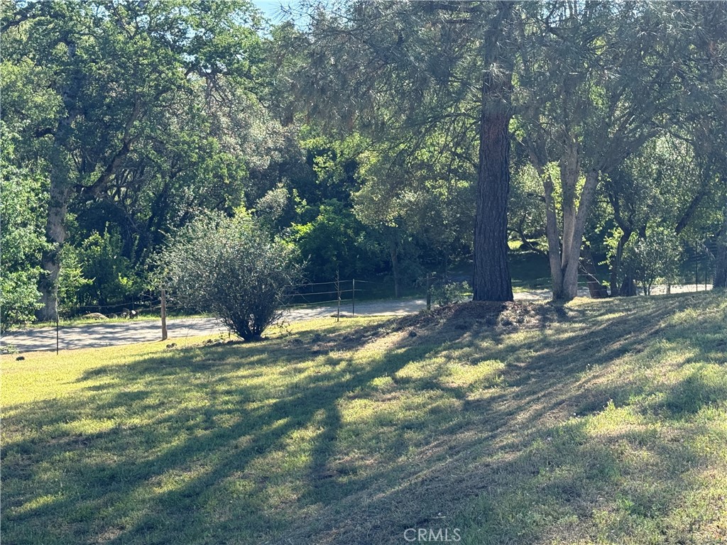 4952 Hidden Springs Road Mariposa, CA 95338 - Photo 52 of 53 a view of a swimming pool with an outdoor space and seating area