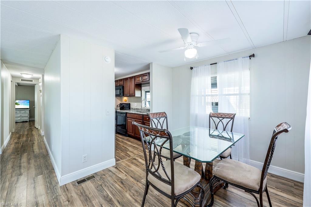 21 Lemans Drive Naples, FL 34112 - Photo 11 of 26 a view of a dining room with furniture and wooden floor