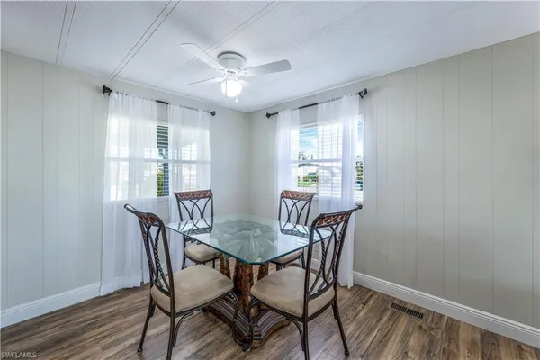 a view of a dining room with furniture window and wooden floor