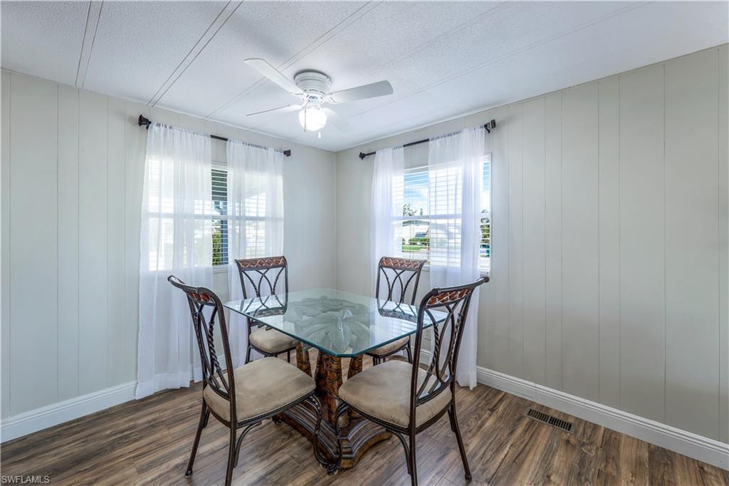 21 Lemans Drive Naples, FL 34112 - Photo 12 of 26 a view of a dining room with furniture window and wooden floor