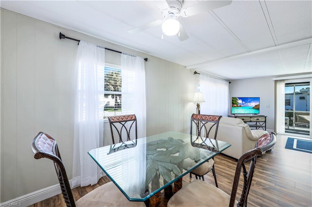 21 Lemans Drive Naples, FL 34112 - Photo 13 of 26 a view of a dining room with furniture and wooden floor