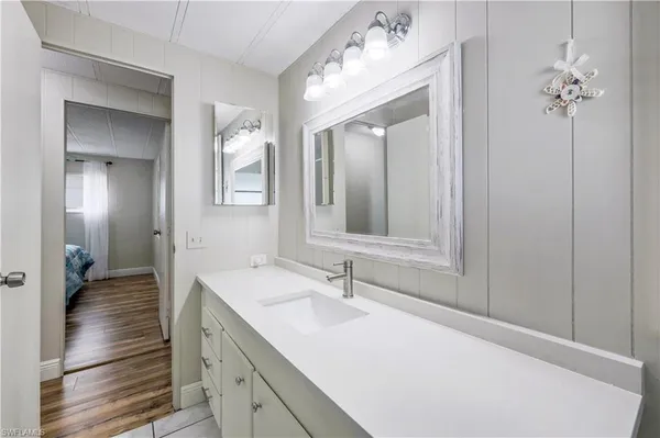 a en suite bathroom with a sink double vanity and a mirror