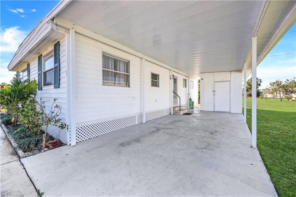 21 Lemans Drive Naples, FL 34112 - Photo 2 of 26 a view of a house with backyard and garden