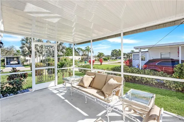 a view of yard from deck with patio