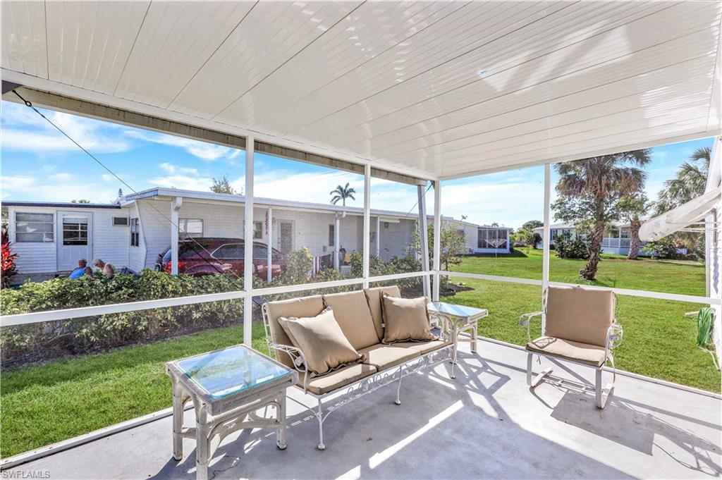 21 Lemans Drive Naples, FL 34112 - Photo 23 of 26 a view of swimming pool with a table and chairs