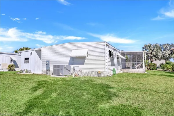 a view of a house with a yard and porch