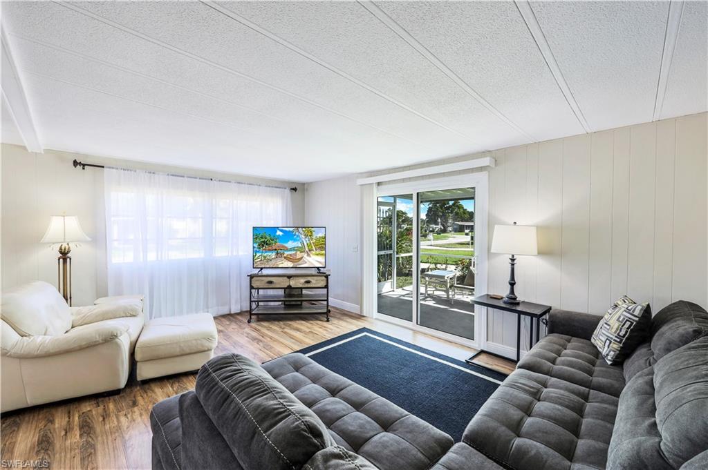 21 Lemans Drive Naples, FL 34112 - Photo 4 of 26 a living room with furniture and a flat screen tv