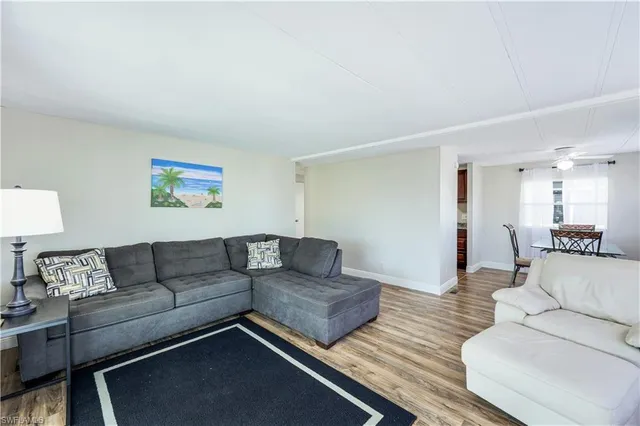 a living room with couches and a night stand