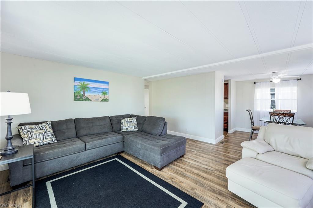 21 Lemans Drive Naples, FL 34112 - Photo 6 of 26 a living room with couches and a night stand